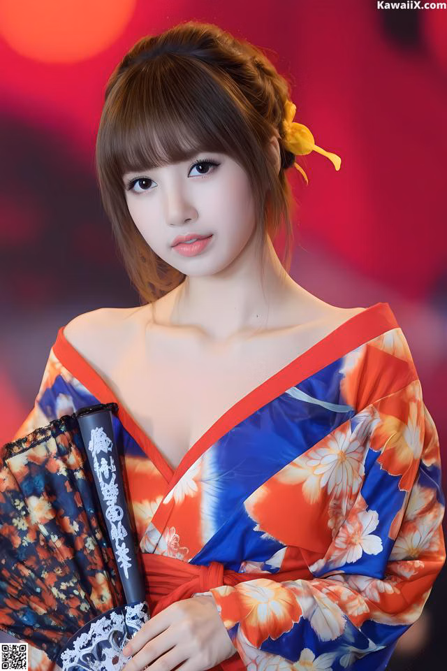A woman in a red and blue kimono holding a fan.