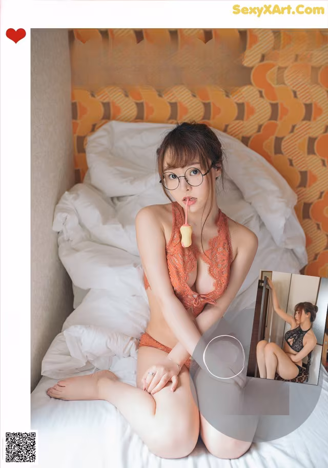A woman in a red lingerie sitting on a bed.