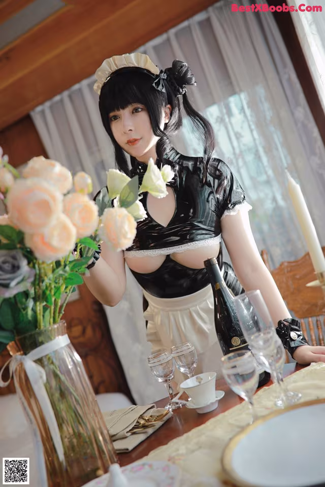 A woman in a maid outfit holding a bouquet of flowers.