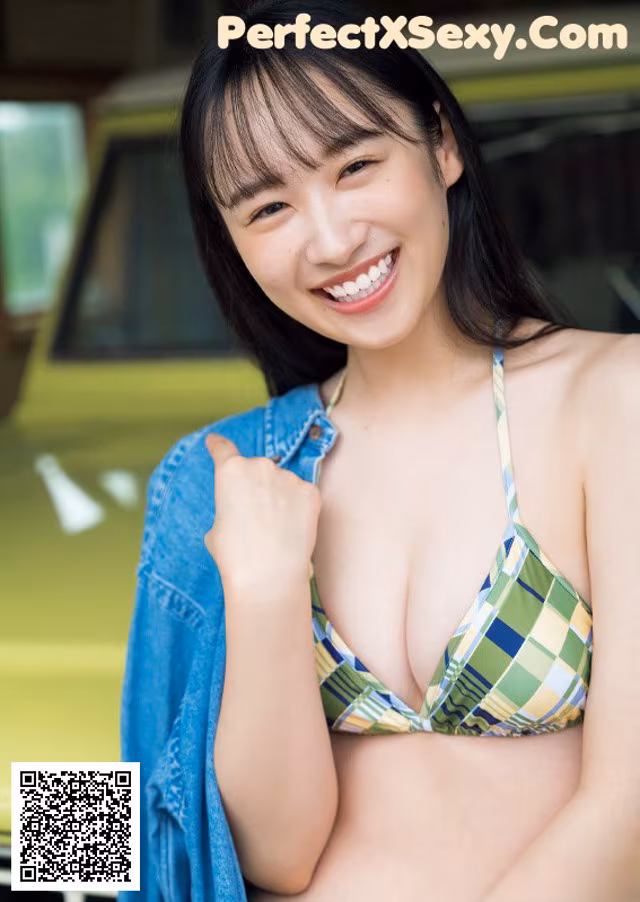 A woman in a bikini posing in front of a yellow car.