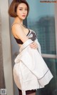 A woman in a black and white dress posing for a picture.